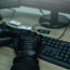 Shot from the Back to Hacker Breaking into Corporate Data Servers from His Underground Hideout. close view of hackers hands