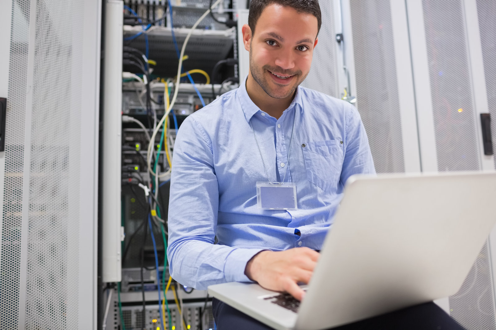 happy-man-using-laptop-to-check-servers